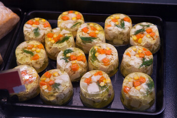 Jellied meat, jelly with chicken and carrots, Russian festive cuisine in the culinary department on the counter of the store.