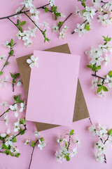 mockup of a spring postcard. blossoming cherry branch and place for text. congratulation. invitation