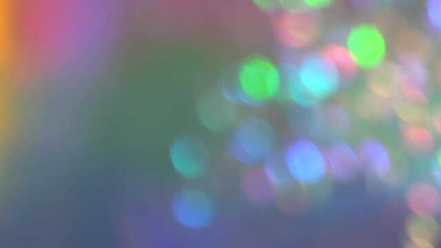 Blurred holographic holiday lights bokeh. Soft pastel neon rainbow colors circles. Luxury background for Christmas party. Posterized Abstract Effect
