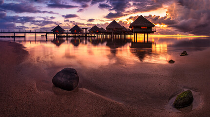 Tahiti bungalows with sunset near beach - obrazy, fototapety, plakaty