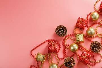 Christmas or new Year pink background with red and gold decorations for Christmas tree with free space.