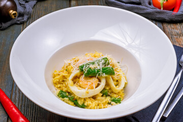risotto with seafood on wooden table