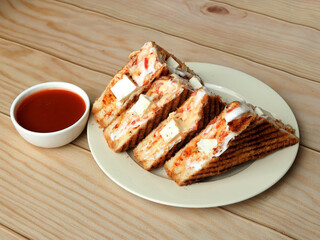 Paneer grilled sandwich served with ketchup, isolated over a rustic wooden background, selective focus