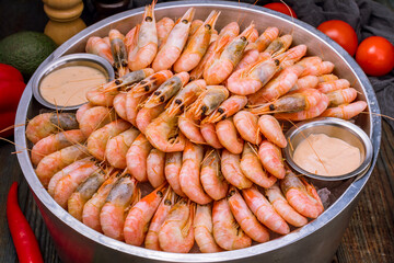 boiled shrimp on ice on dark blue table
