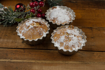 christmas decorated cupcakes on wooden background top view