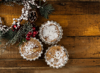 christmas decorated cupcakes on wooden background top view