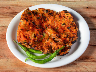 Churchur naan, isolated over a rustic wooden background, selective focus