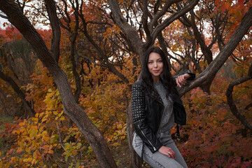 Autumn woman in the autumn park. Warm weather.