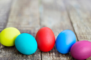 Fototapeta na wymiar colorful easter eggs on wooden background with copy space. Easter background