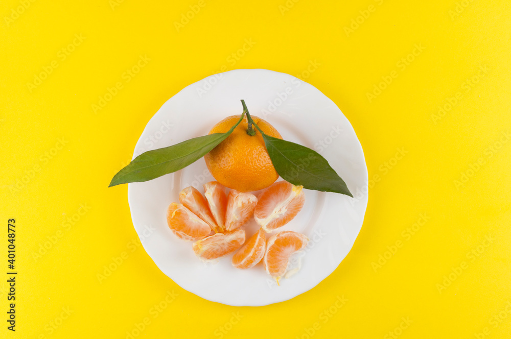 Wall mural fresh oranges bowl on yellow background