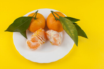 Fresh oranges bowl on yellow background
