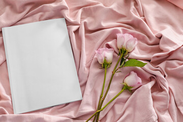 Blank magazine and flowers on cloth