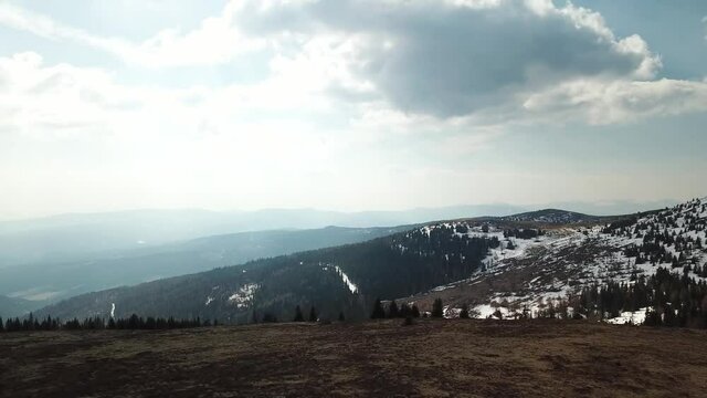A panoramic view from the Seiner Kreuz, a peak in Austrian Alps. There are a few snow fields around. Early spring in the mountains. Endless mountain chains in the back. Wanderlust. Raw landscape
