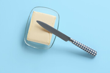 Bowl with fresh butter on color background