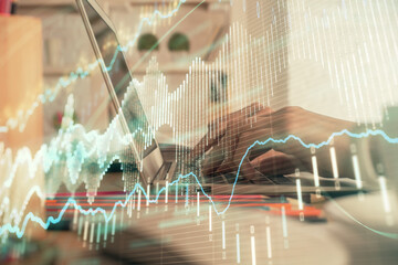 Double exposure of woman hands typing on computer and forex chart hologram drawing. Stock market invest concept.