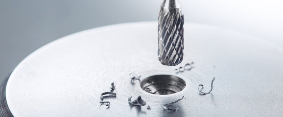 end mill bit cutting big hole in a steel billet