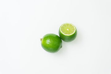 Ripe green lime citrus lime slice on white background.