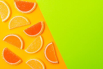 Natural marmalade on combined green and orange background with copy space.