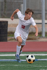 Young athletic boy making exciting plays during a soccer game
