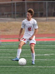 Young athletic boy making exciting plays during a soccer game