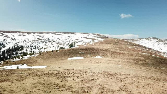 A panoramic view from the Seiner Kreuz, a peak in Austrian Alps. There are a few snow fields around. Early spring in the mountains. Endless mountain chains in the back. Wanderlust. Raw landscape
