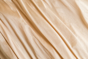 Shiny satin silk fabric with folds background texture textile.