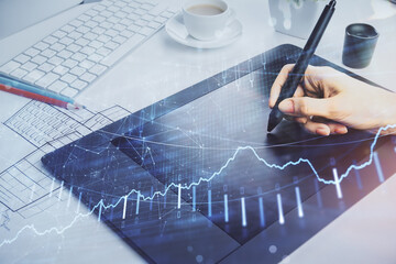 Double exposure of financial graph sketch hologram and woman holding and using a mobile device....