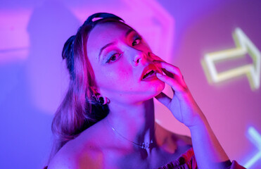 Colorful portrait of a club party woman with multicolored dynamic projector lighting.