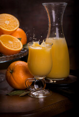glass of fresh orange juice with fresh fruits on wooden
