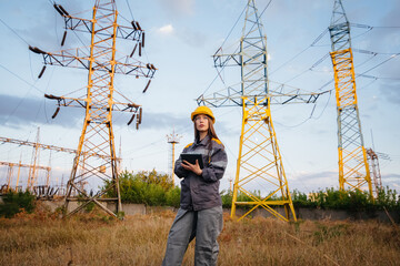 A young engineering worker inspects and controls the equipment of the power line. Energy