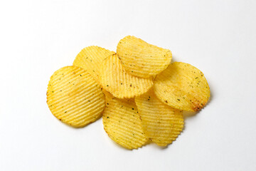 One of the types of snacks, fast food, junk food - ruffled potato chips on a white background. Pile of  ruffled potato chips with copy space