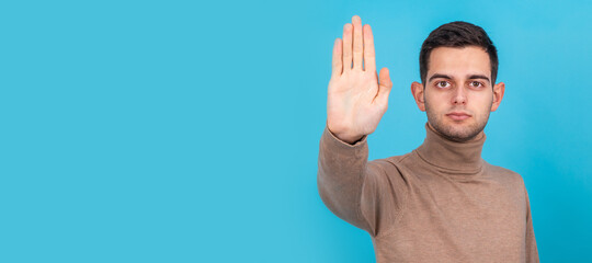 man isolated on background with hand on stop sign
