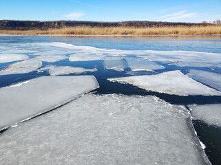 Ice floes float on the river. Thaw at the end of winter