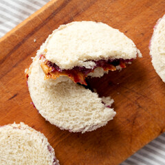 Homemade Crustless Peanut Butter  and Jelly Circles on a rustic wooden board, overhead view. Flat lay, top view, from above. Close-up.