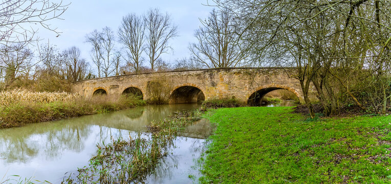 A panorama view of the southern bridge in Oundle, UK on a bright sunny day