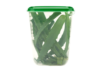 Plastic container with chopped aloe cactus leaves. Container with aloe on a white background.