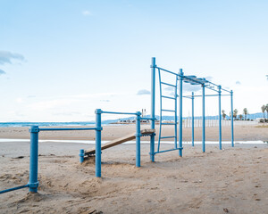 Calisthenics park on the beach. Outdoor gym for street workout and the view of the sea on the background.