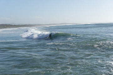 surfer enjoying a surf session at Sao Torpes Beach in Sines on the Alentejo Coast