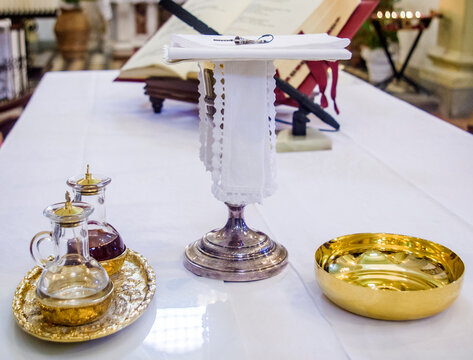 chalice for wine, blood of christ, and ciborium with host, body of christ, and ampoules with wine and water for consecration