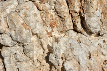 Textured stone, sandstone, limestone surface. Close image. Stone, natural abstract texture for backgrounds. Close up. Wallpaper, architecture.