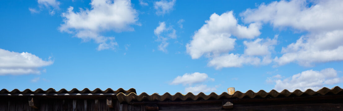 Abstract image of blurred sky. Old roof against the blue sky background