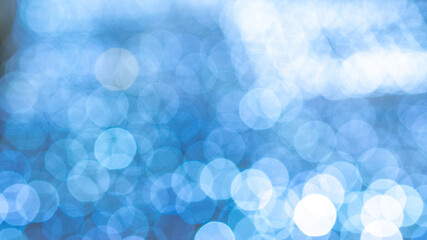 Bokeh fashion. Blue glitter abstract lights. Festive blur background. Soft yellow christmas backdrop.