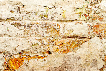 Texture of a brick wall with cracks and scratches which can be used as a background