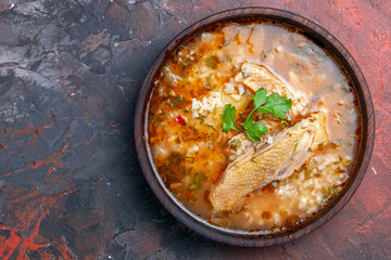 top view homemade chicken and rice soup on dark background with free space
