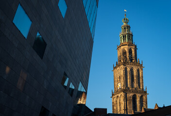 Forum building and the historical Martinitower in Groningen on a sunny morning.