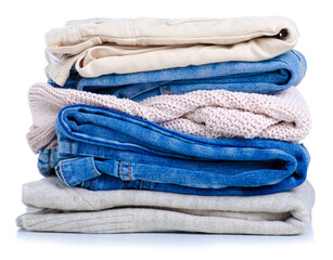 Stack folded jeans sweaters on white background isolation