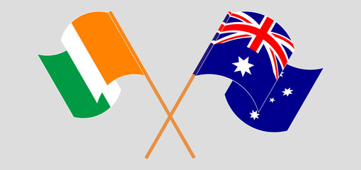 Crossed and waving flags of Republic of Ivory Coast and Australia