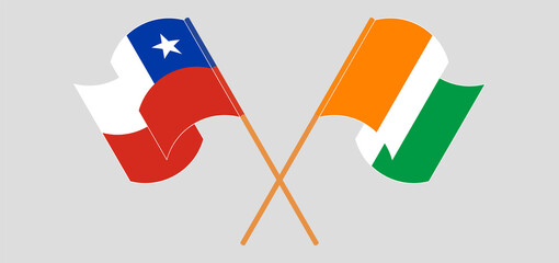Crossed and waving flags of Chile and Republic of Ivory Coast