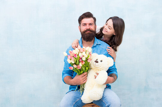 Father And Daughter Embrace With Spring Tulip Flower Bouquet And Teddy Bear Toy, Fathers Day