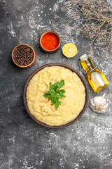 top view mashed potatoes in wooden bowl pepper red pepper in small bowls oil garlic on dark background with free space